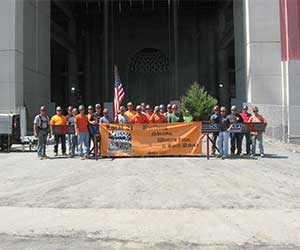 Ironworkers Local 21 Group Members Standing Before Iron Doors